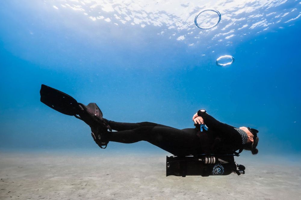 A Avelo scuba diver steadying themselves in calm water