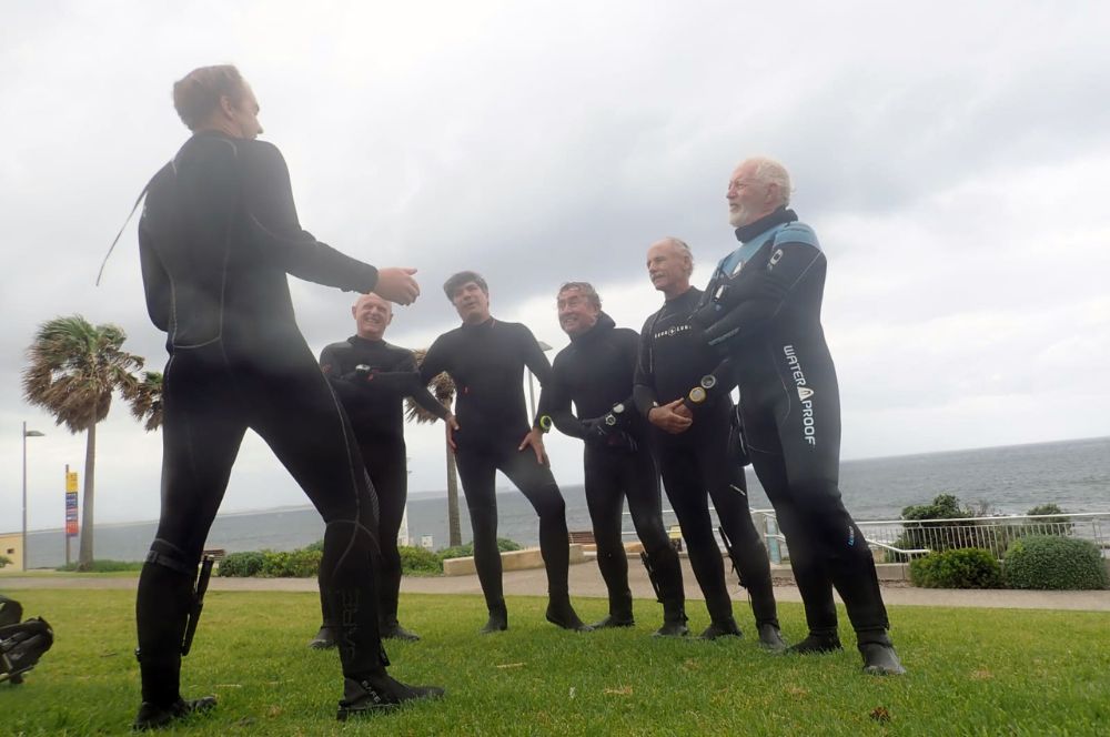 Dive plan being reviewed by scuba divers before a dive.