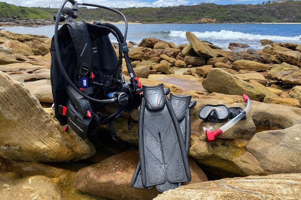 Essential scuba diving equipment laid out for a dive.