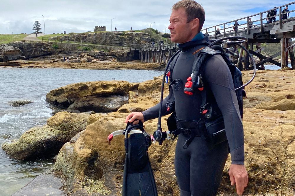 A PADI instructor guiding a student diver during a lesson.